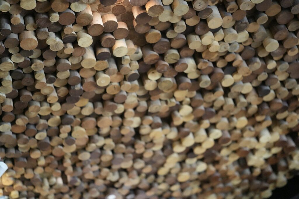 Close-up of many small wooden dowels hanging